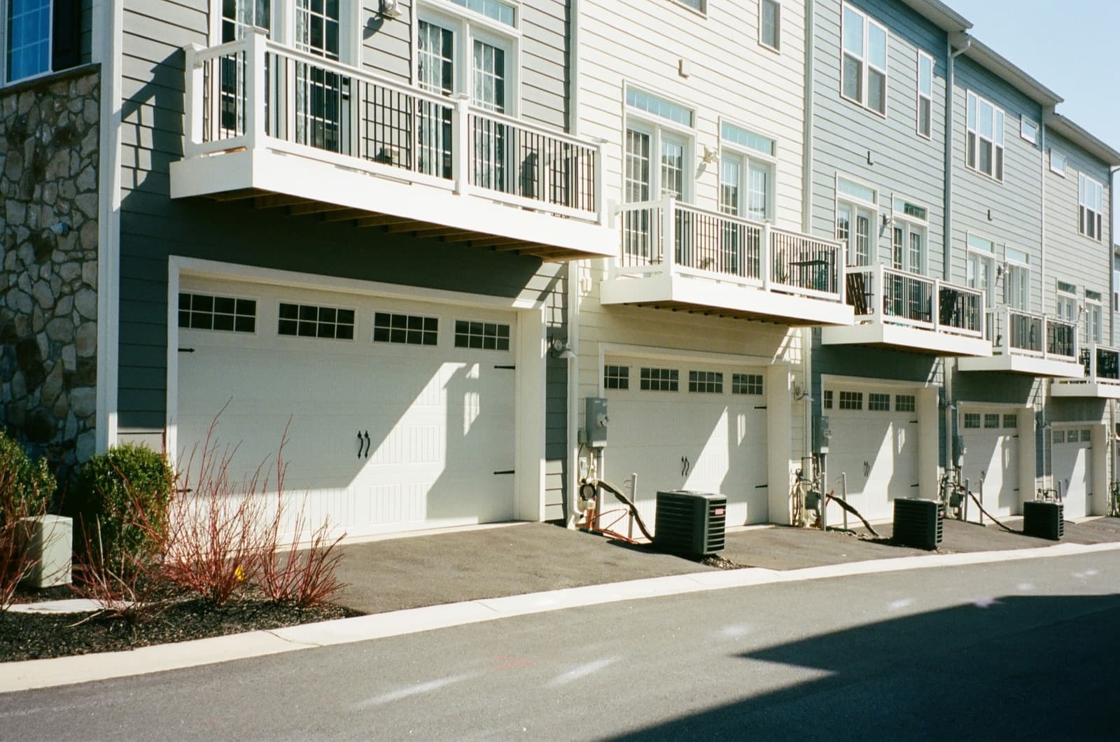 Townhomes with coordinated windows, doors, and garages