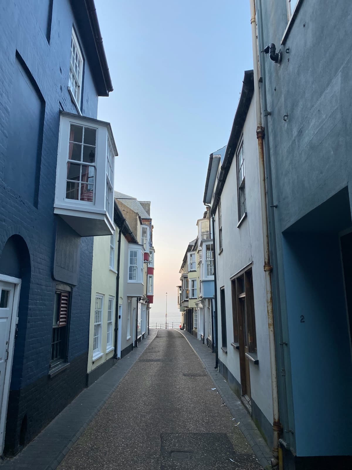 Historic coastal street lined with bay windows