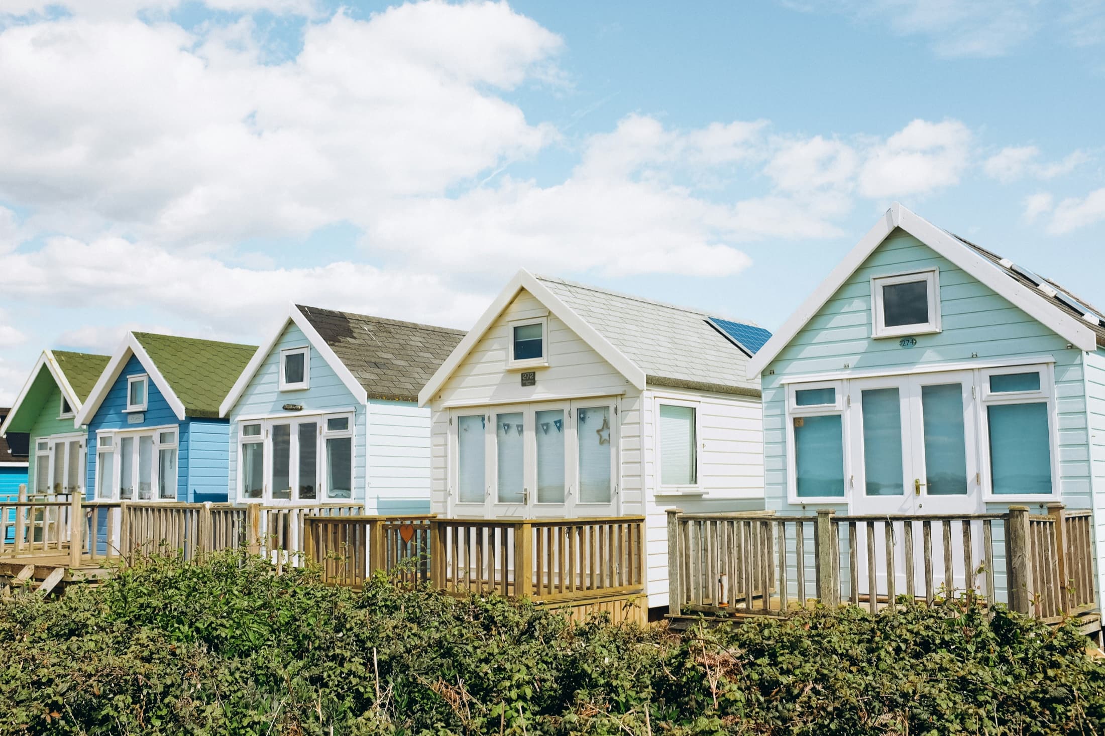 Colorful coastal homes with windows and glazed doors