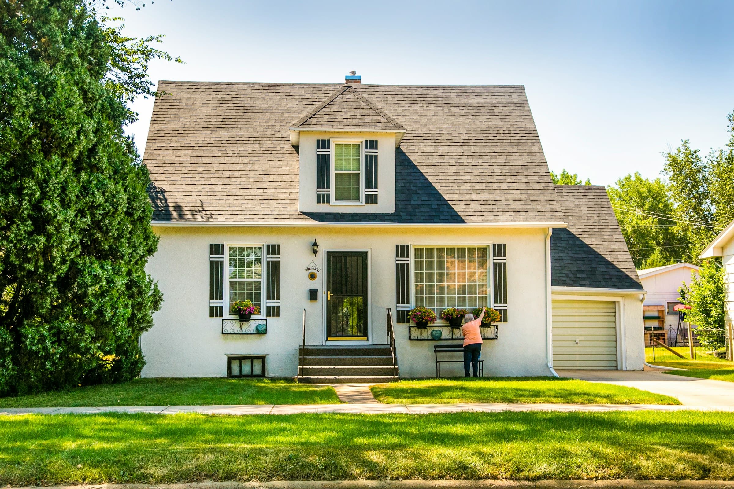 A well-maintained house with several visible window styles